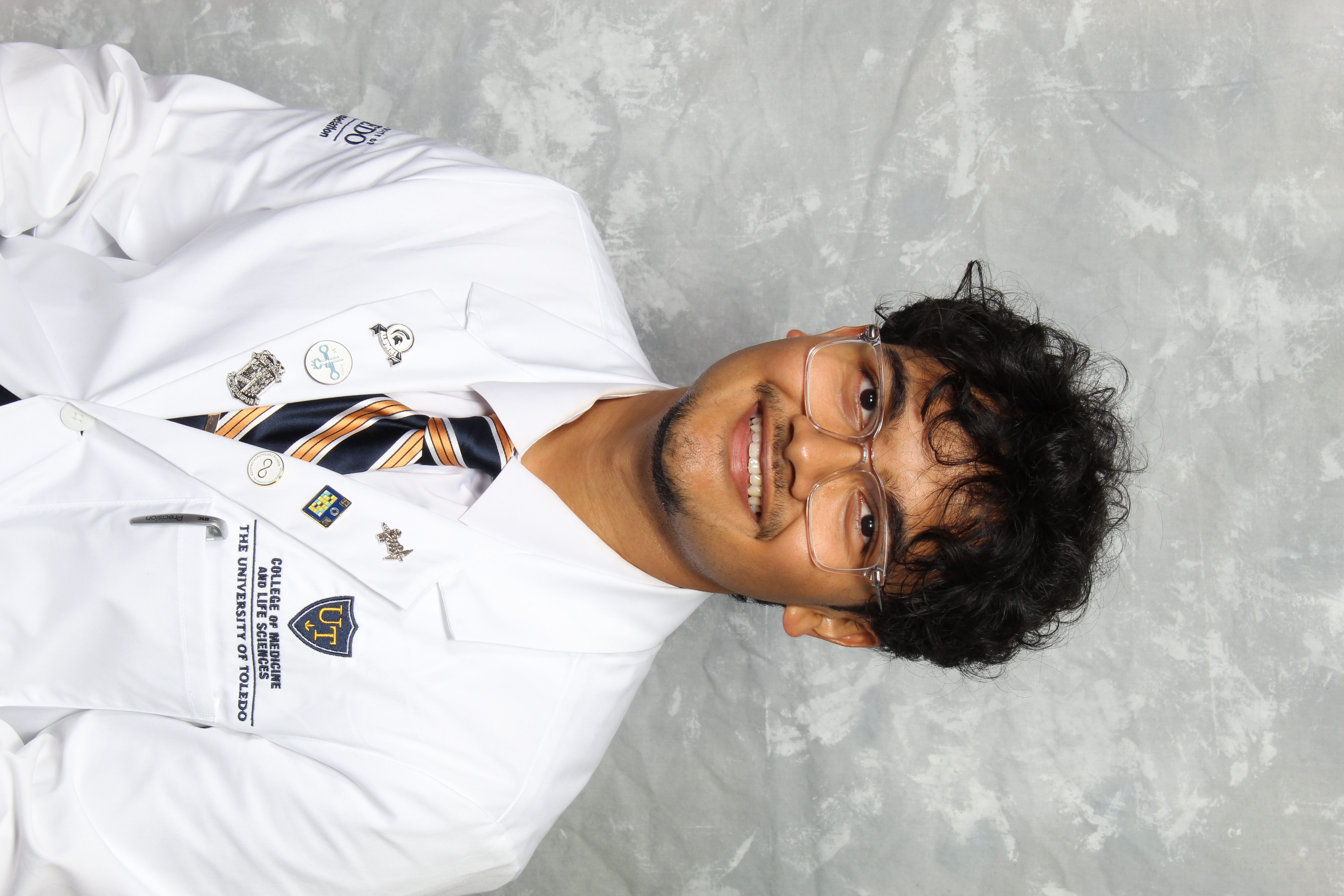 Headshot of Arkesh Das in a white coat.